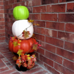 Beautiful, finished pumpkin topiary sitting on a porch