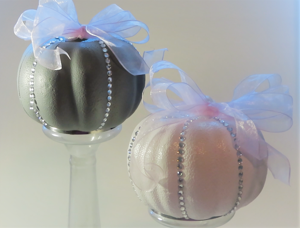 Decorated Styrofoam pumpkins on clear candlestick holders