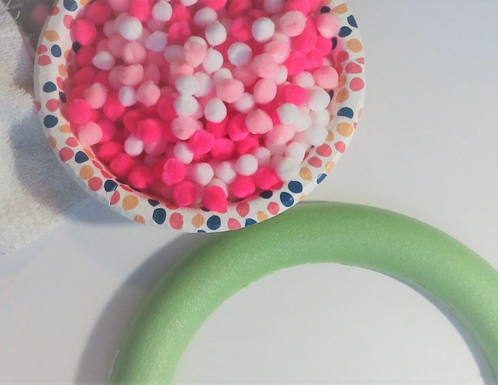 Placing the felt ball poms randomly in a bowl | How to Make an Easy Pom Pom Wreath