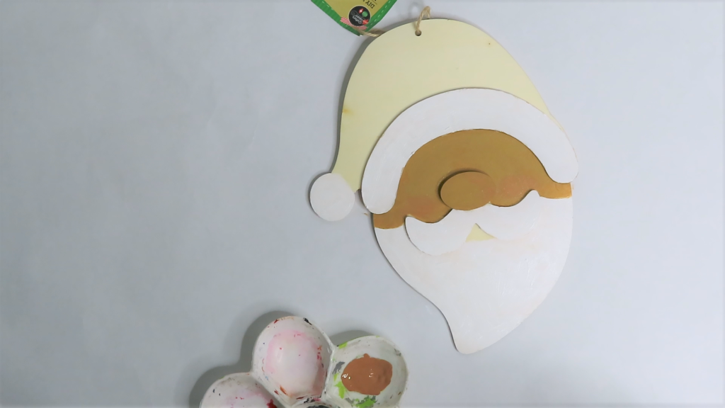 Add a little red acrylic craft paint to Santa's rosy cheeks | How to Turn a Dollar Tree Santa Head into a Masterpiece