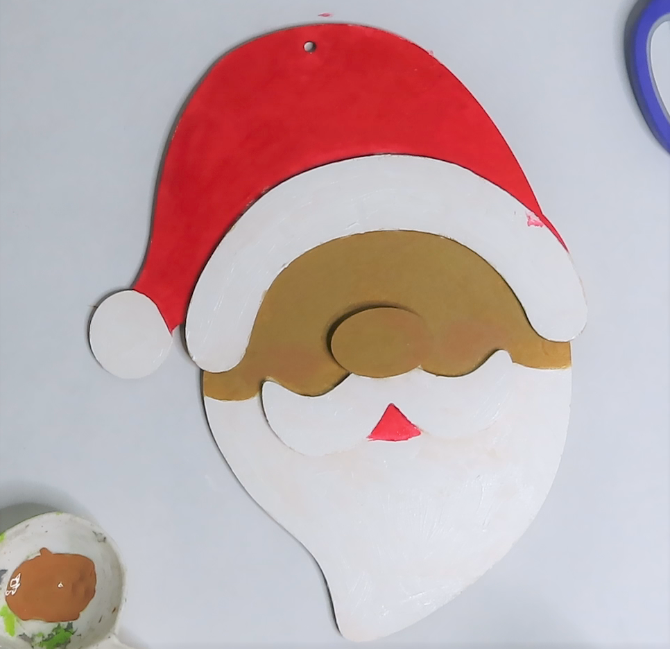 Paint Santa's hat and mouth with red acrylic craft paint | How to Turn a Dollar Tree Santa Head into a Masterpiece
