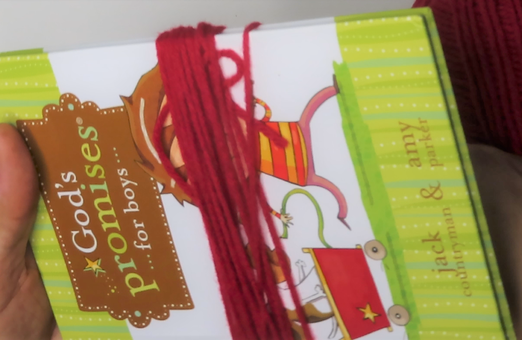 Wrap yarn around a small book | Make Your Own Tassel Garland In No Time