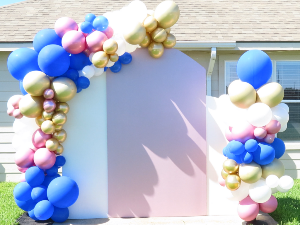 Completed DIY chiara backdrop with balloon garland and balloon column