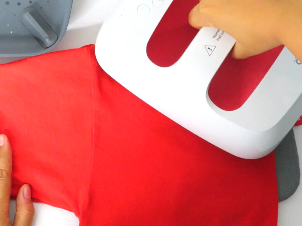 Fold the shirt in half and use the heat press to mark the spot