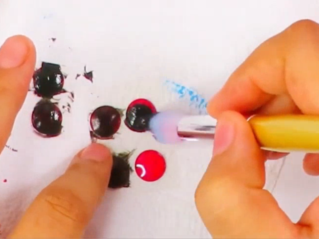 Paint the colorful popup stickers with black acrylic craft paint.