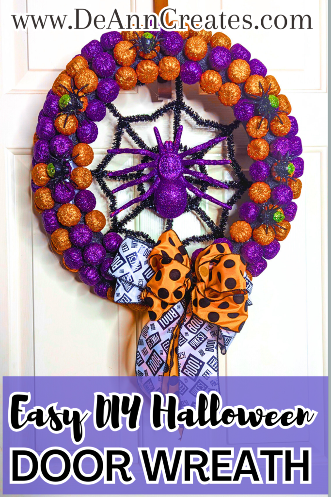 This pin is entitled Easy DIY Halloween Door Wreath. The image features a Halloween wreath covered with purple and orange glittery pumpkins with six black and green glittery spiders on top. In the center of the wreath there is a black tinsel spider web with a large purple glitter spider in the center. In the bottom center of the wreath their is a bow made up of two different ribbons: A black and white ribbon and an orange ribbon with black polka dots. | How to Make a DIY Wreath with Glittery Spiders
