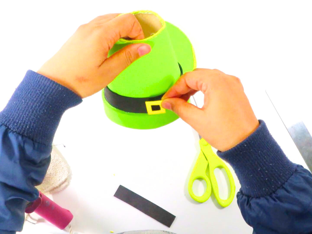 How to Make a Leprechaun Trap for St. Patrick's Day Fun | Gluing the buckle to the band of the hat