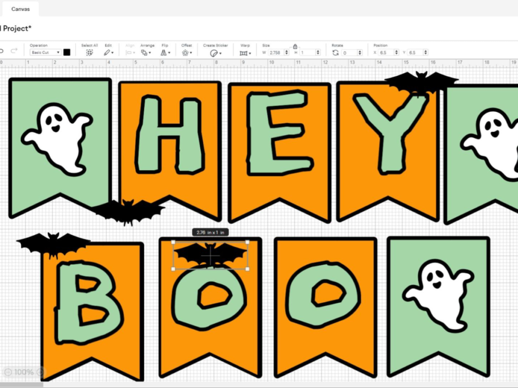 This image shows the "Hey Boo" banner being designed on Cricut Design Space after adding the little black bats to the layout. | How to Make a Banner for Halloween That's Cute and Spooky